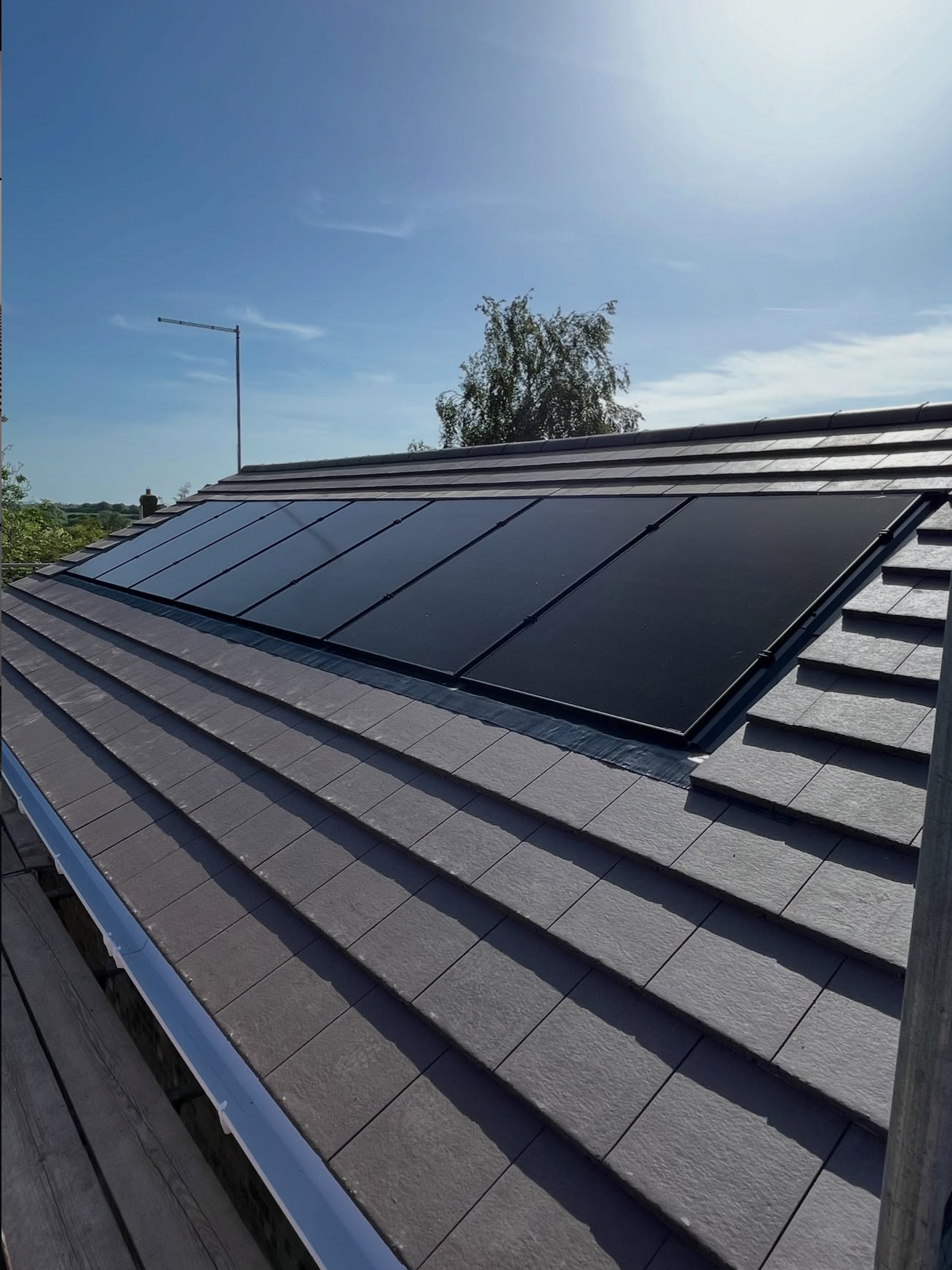In-roof solar panels integrated flush with a tiled roof